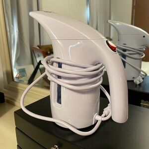 Like new garment steamer. Used once. hasbrush attachments. Distilled water rec.